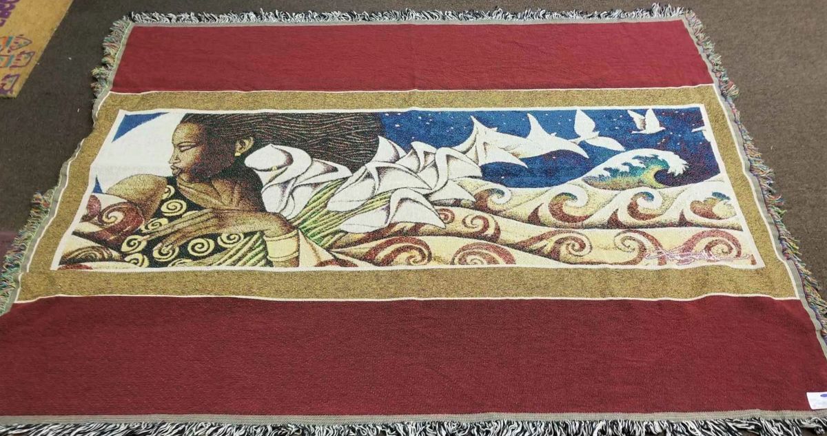 Woman on the Waves Throw Blanket flat on carpet