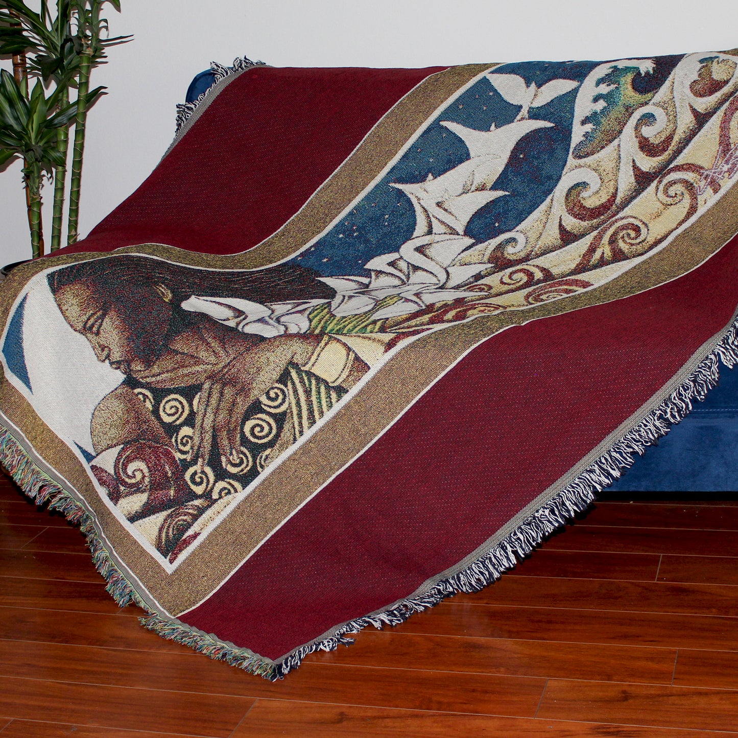 Woman on the Waves Throw Blanket draped on sofa.