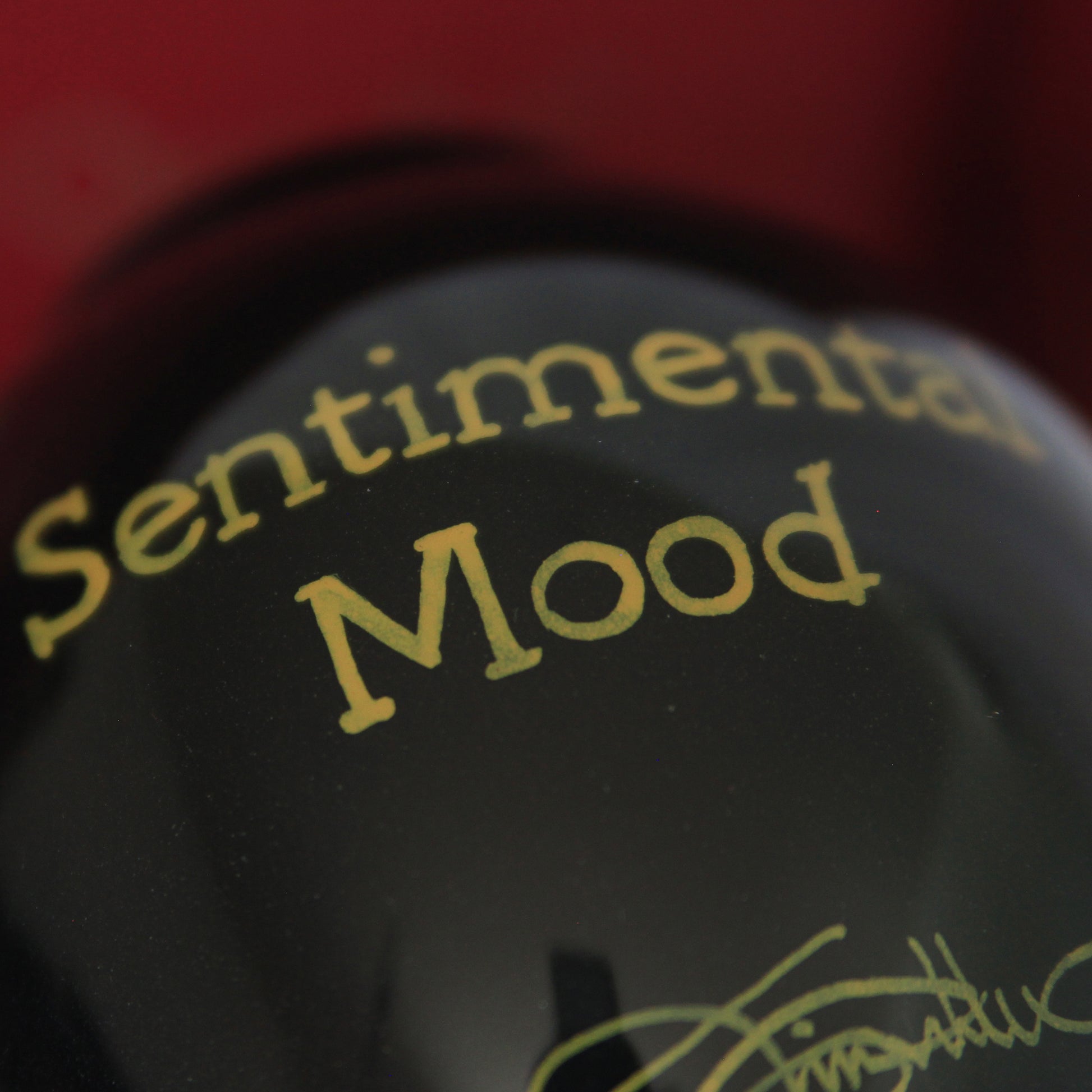 ne'qwa ornament rear design gold text reads "Sentimental Mood"  on black glass