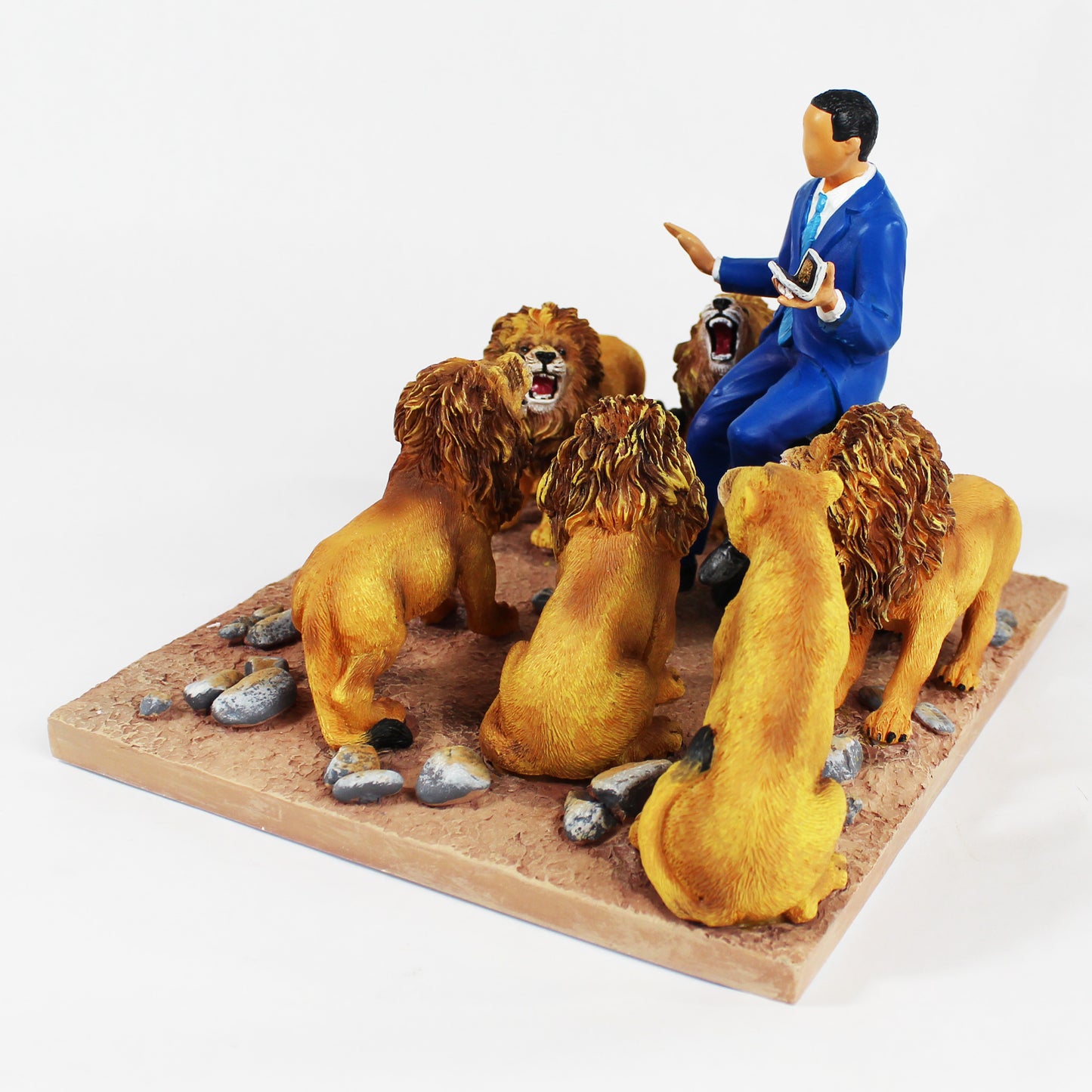 President Obama In The Lion's Den figurine. President sitting on a stump surrounded by six fierce lions - side