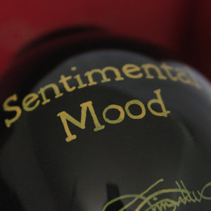 ne'qwa ornament rear design gold text reads "Sentimental Mood"  on black glass