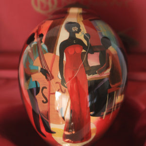 In a Sentimental Mood ne'qwa ornament front design of a female singer in a red dress accompanied by a bass player and piano man