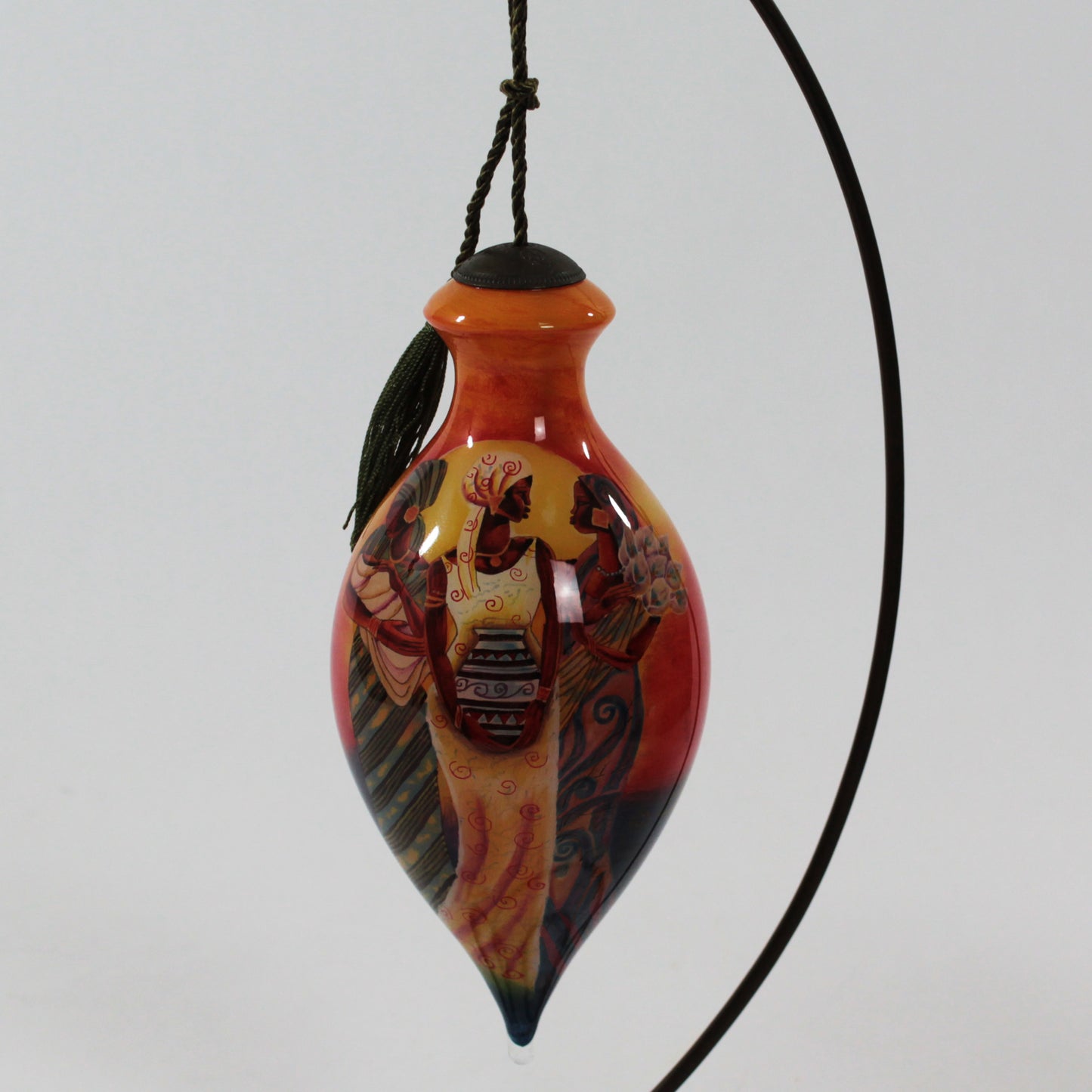 Sisters of the Sun Ne'Qwa Art Glass Ornament by Keith Mallett hanging